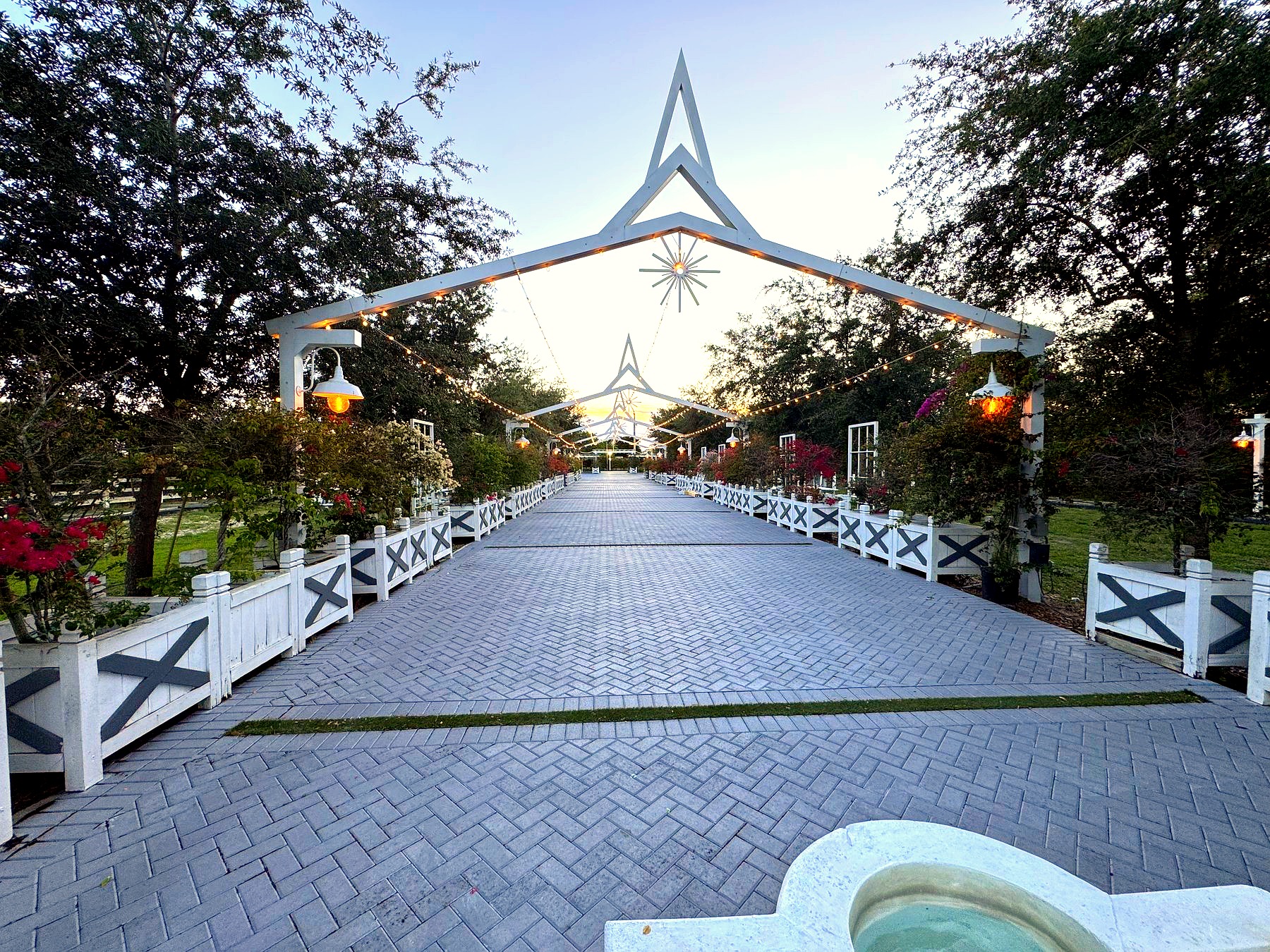 The arched entrance of The White Barn at golden hour